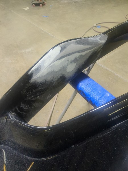 Bumper repair in progress — close-up of bodywork
