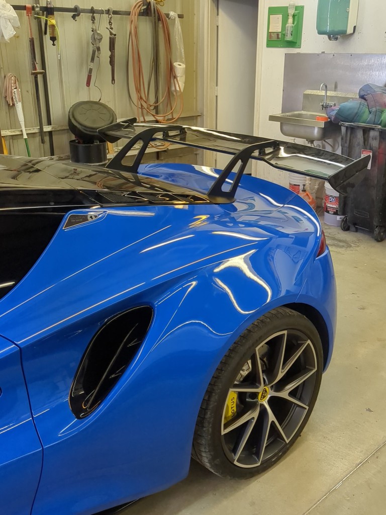 Close-up of wing and bracket fitment on Lotus Emira